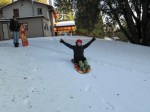 Eileen Truberman sledding in the snow