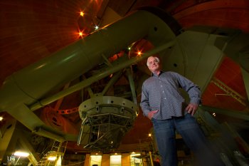 Music composer Larry Groupe stands under the dome of the 200-inch telescope operated by California Institute of Technology.  In late August Groupe will premiere a new piece for a string quartet which will be performed on the observatory floor of the Palom